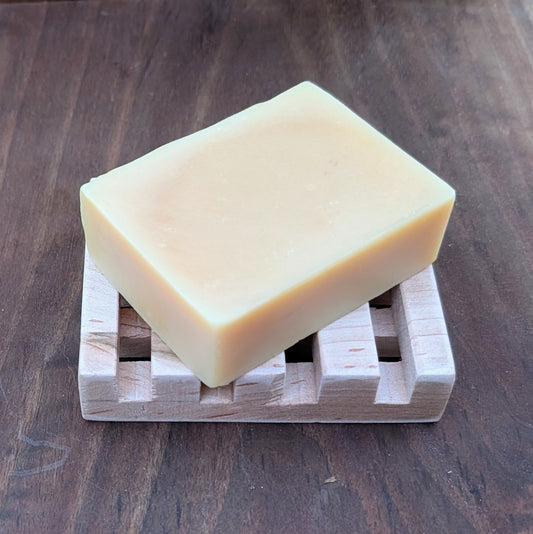 Handmade maple wood soap dish with Bloom 'n Goat goat milk soap bar on a walnut wood background made in Tennessee